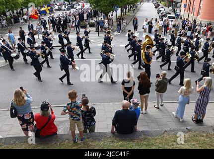 Glückliche Studenten während des Abschlussjahrs (auf Schwedisch: Studenten) in Mjölby, Schweden. Hier ist ein Orchester mit den Studenten dahinter. Stockfoto