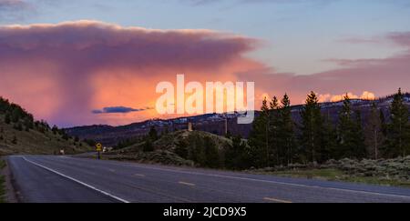 Ein schöner roter Sonnenuntergang über den Bergen, die von Nadelwäldern überwuchert sind. USA Stockfoto