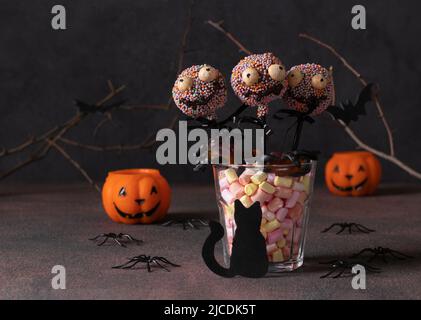 Hausgemachte Halloween-Kuchen knallt Monster mit dunkler Schokolade. Süßigkeiten für Kinder auf Halloween-Party Stockfoto