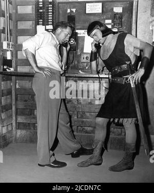 ROBERT WAGNER und Unidentified Crew Member am Set telefonieren auf der Studio Sound Stage während der Dreharbeiten von PRINCE VALIANT 1954 Regisseur HENRY HATHAWAY nach The King Features syndiziert Comic Strip von Harold / Hal Foster Drehbuch Dudley Nichols music Franz Waxman Garderobe Director Charles Le Maire Twentieth Century Fox Stockfoto