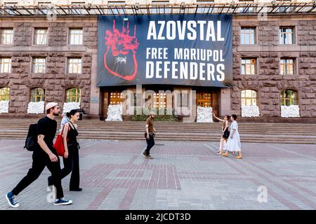 Kiew, Ukraine. 12.. Juni 2022. Eine große Plakatwand mit einem Schild "Azowstal. Free Mariupol Defenders' ist am 12. Juni 2022 in einem Gebäude des Stadtrates in der Altstadt von Kiew, Ukraine, zu sehen. Als die Russische Föderation vor mehr als 3 Monaten in die Ukraine einmarschierte, dauern die heftigen Kämpfe im Osten des Landes an. Die Hauptstadt Kiew bleibt in relativer Sicherheit, obwohl in der ganzen Stadt Erinnerungen an den Krieg wie schützende Sandsäcke, Straßensperren, nationale und Anti-Kriegs-Symbole zu sehen sind. (Foto von Dominika Zarzycka/Sipa USA) Quelle: SIPA USA/Alamy Live News Stockfoto