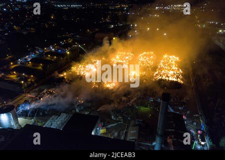 Nechells, Birmingham, England, 12. Juni 2022. Mehr als 100 Feuerwehrleute bekämpfen ein riesiges Inferno auf dem Smurfit Kappa Recycling Compound in Nechells, Birmingham. Die West Midlands Fire Service hat 20 Geräte installiert, darunter zwei hydraulische Hubarbeitsbühnen, mehrere Löschfahrzeuge und eine Hochvolt-Wasserpumpanlage. Bei dem Vorfall werden 8000 Tonnen Papier- und Pappballen in einem Lagerhaus in Brand gesetzt. Quelle: Stop Press Media/Alamy Live News Stockfoto