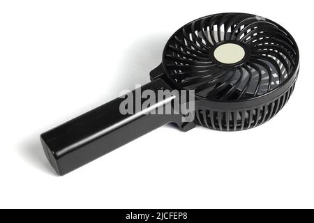 Mini Hand Held Electric Fan auf weißem Schwarzboden Stockfoto