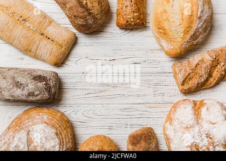 Hausgemachtes natürliches Brot. Verschiedene Arten von frischem Brot als Hintergrund, Draufsicht mit Kopierraum. Stockfoto