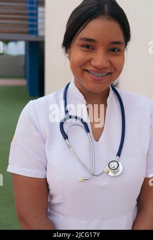 Porträt einer lächelnden Krankenschwester vor einem Krankenhaus Stockfoto