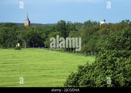 27. Mai 2022, Brandenburg, Lenzen (Elbe): Die Wiesen am Elbdeich nahe der Anlegestelle der Fähre Pevestorf-Lenzen vor der Kulisse der Türme von Schloss Lenzen (r) und St. Katharinenkirche. Foto: Soeren Sache/dpa Stockfoto