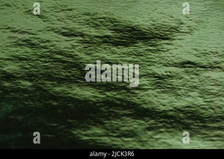 Sattgrüner Hintergrund mit Lichtreflexion. Anahata Chakra Farbton. Stockfoto