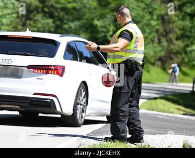 Griesen, Deutschland. 14.. Juni 2022. Ein Bundespolizist kontrolliert den Verkehr an der Grenze auf der B 23 in Griesen. Der Gipfel G7 ist für den 26. Und 28. Juni 2022 auf Schloss Elmau geplant. Quelle: Angelika Warmuth/dpa - ACHTUNG: Nummernschild(e) aus rechtlichen Gründen pixelig/dpa/Alamy Live News Stockfoto