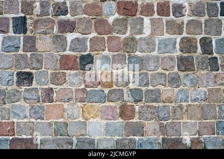 Hintergrund einer alten Mauer aus Naturstein Stockfoto