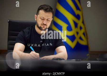 Kiew, Ukraine. 14.. Juni 2022. Der ukrainische Präsident Wolodymyr Zelenskyy nimmt sich während einer Online-Pressekonferenz für die dänischen Medien aus seinem Situation Room am 14. Juni 2022 in Kiew, Ukraine, Notizen. Kredit: Ukrainisches Presidential Press Office/Ukraine Presidency/Alamy Live News Stockfoto