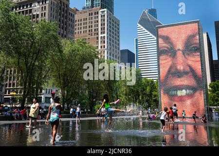 Chicago, USA. 14.. Juni 2022. Am 14. Juni 2022 spielen die Menschen am Crown Fountain in der Innenstadt von Chicago, den Vereinigten Staaten, mit Wasser. Die Metropolregion Chicago ist auf eine Hitzewelle in der Schwebe, da der US-Wetterdienst am Montag eine Wärmeempfehlung für die Region herausgab. Kredit: Vincent D. Johnson/Xinhua/Alamy Live Nachrichten Stockfoto