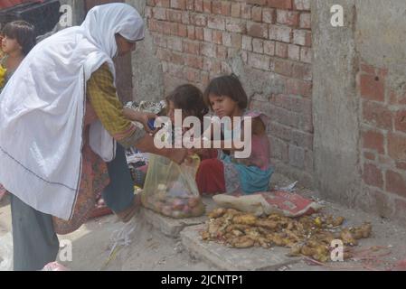 Lahore, Punjab, Pakistan. 12.. Juni 2022. Pakistanische Zigeunerhändler Kinder verkaufen Gemüse auf dem Badami Bagh Gemüsemarkt, als Worldwide den Internationalen Tag gegen die Kinderarbeit in Lahore feiert. (Bild: © Rana Sajid Hussain/Pacific Press via ZUMA Press Wire) Stockfoto