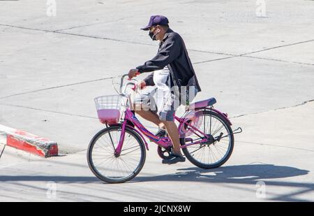 SAMUT PRAKAN, THAILAND, JUNI 10 2022, Ein Mann fährt auf einem Fahrrad auf der Stadtstraße. Stockfoto