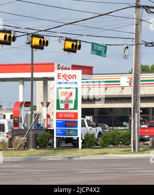 Ein Zeichen, das Aufwandsbenzinpreise an einem 7-11 conveneince Speicher annonciert, der Exxon gebrandmarkt Gas verkauft Stockfoto