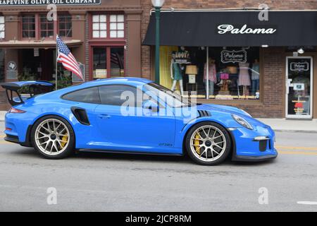 Ein hellblauer Porsche GT3RS, der die Main Street in Grapevine Texas entlang fährt Stockfoto