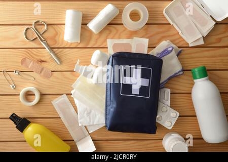 Tragbare erste-Hilfe-Ausrüstung für Freizeit- oder Sportveranstaltungen auf Holztisch. Horizontale Zusammensetzung. Draufsicht. Stockfoto