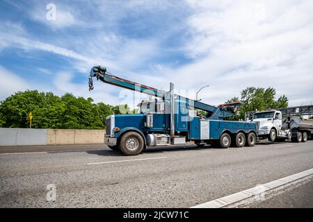 Leistungsstarke mobile Helfer schwere blaue Big-Rig Abschleppen Sattelschlepper mit erweiterten Pfeil Abschleppen außer Betrieb erhöhte gebrochene Sattelschlepper zu Auto rep Stockfoto