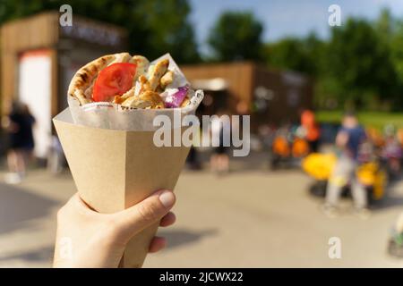 Griechische Street Food Gyros in der Hand. Griechische und mediterrane Küche mit Fleisch in Pita. Hochwertige Fotos Stockfoto