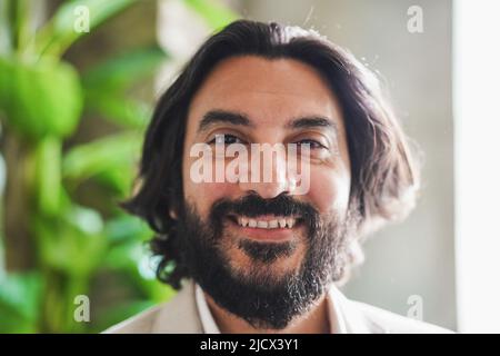 Reifer indischer Geschäftsmann, der im Büro arbeitet - Hauptfokus auf Nase Stockfoto