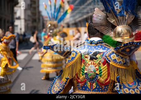 Bunte Maskentänzer in gelbem Kleid feiern während des bolivianischen Festivals der Jungfrau von Urkupiña in den Straßen von Mailand, Italien, Europa Stockfoto