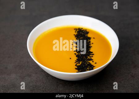 Kürbissuppe mit schwarzen Sesamsamen bestreut. Gesunde Ernährung. Stockfoto