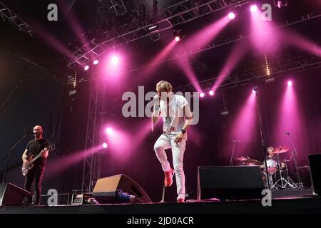 Newport, Großbritannien. 16.. Juni 2022. Von l-r, Gitarrist Jo, Sänger Rick Parfitt Jnr, Sohn des verstorbenen Rick Parfitt, Gitarrist bei Status Quo, und Schlagzeuger Alex Toff, die live auf der Bühne mit der Rick Parfitt Jnr Band bei der Eröffnung in The Big Top während des Isle of Wight Festivals auftreten. Kredit: SOPA Images Limited/Alamy Live Nachrichten Stockfoto