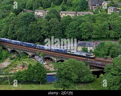 Die GBRF-Diesellokomotive 66794 wird den Rochdale-Kanal bei Todmorden im Calder-Tal mit einer Zuglast aus Stein in Richtung Manchester überqueren Stockfoto