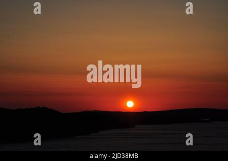 Silhouetten der Möwe des roten Sonnenuntergangs. Möwe in Sonnenuntergang Himmel. Bei Sonnenuntergang fliegende Möwen über dem Meer. Möwen auf See . Vögel fliegen zurück nach Hause bei Sonnenuntergang Meere Stockfoto