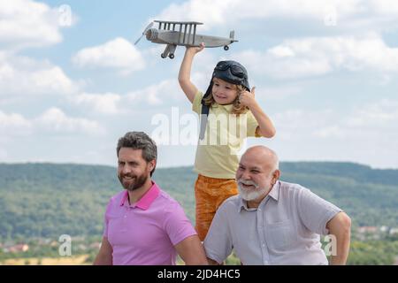Männer Generation: Großvater Vater und Enkel spielen mit Spielzeug Flugzeug im Freien am Himmel. Junge träumt davon, Pilot zu werden. Stockfoto