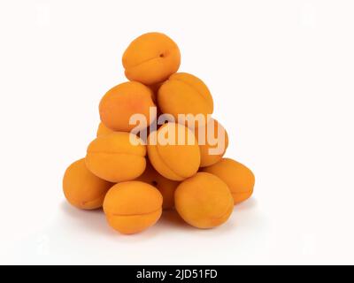 Haufen frischer Aprikosenfrüchte isoliert auf hellem Hintergrund. Gesunde frische Lebensmittel Obst Konzept. Nahaufnahme Stockfoto