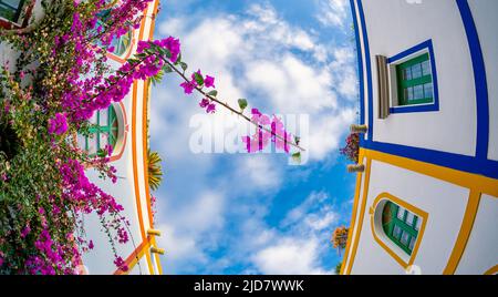 Februar 3 2022 Puerto de Mogan Kanarische Inseln Spanien eine Stadt voller enger Straßen mit rosa roten und orangen Blumen Gewölbe mit bunten Gebäuden mit Stockfoto