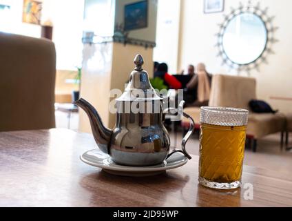 Minztee wird im Metallkessel im Café in Marrakesch, Marokko, serviert Stockfoto