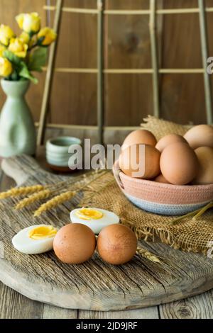 Country-Szene von einem Korb voller Eier mit ganzen und gekochten Eier vor. Stockfoto