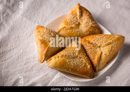 Rohige Kuchen mit Suluguni-Käse, bestreut mit Sesamsamen Stockfoto