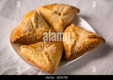 Rohige Kuchen mit Suluguni-Käse, bestreut mit Sesamsamen Stockfoto
