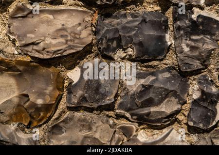 Nahaufnahme verschiedener Feuersteine, die in Großbritannien als Baumaterial in der Architektur verwendet werden. Flint ist der härteste Baustein, der von den Römern verwendet wird. Stockfoto