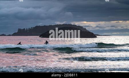 Surfer sitzen auf ihren Surfbrettern in der Brandung am beliebten Surfziel am Chesterman Beach am Pazifikrand von Vancouver Island Stockfoto
