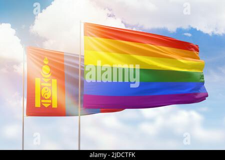 Sonniger blauer Himmel und Flaggen der lgbt und der mongolei Stockfoto