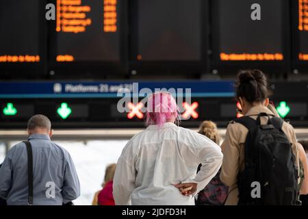 Stunden vor der Schließung des britischen Eisenbahnnetzes, wenn Eisenbahnarbeiter der RMT-Gewerkschaft im gesamten Vereinigten Königreich Arbeitskampfmaßnahmen ergreifen, während der dreißigjährigen Bahnstreiks in England, Schottland und Wales die meisten Störungen ausgingen, Passagiere während der abendlichen Hauptverkehrszeit am 20.. Juni 2022 durch den Waterloo-Hauptbahnbahnhof fahren, In London, England. Stockfoto