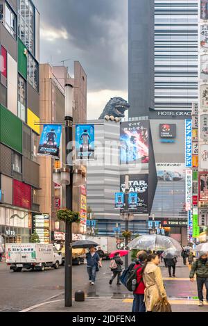 tokio, japan - 07 2019. april: Central Road of Kabukicho in Shinjuku mit seiner Godzilla-Statue und während der Veröffentlichung des Films mit Werbebannern von Stockfoto