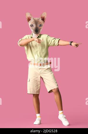 Lustig tanzende Sphynx Katze mit menschlichem Körper auf rosa Hintergrund Stockfoto