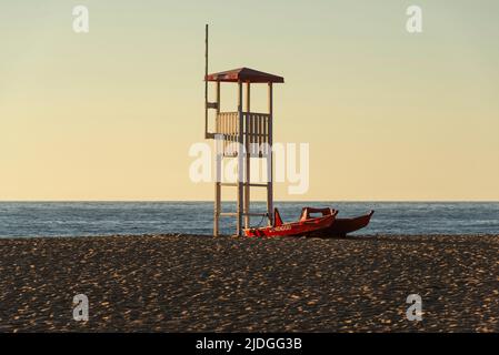 Salvataggio Rettungsschwimmer Wachturm und Rettungsboot am Sandstrand von Piscinas Dünen im goldenen Licht bei Sonnenuntergang, Costa Verde, Sardinien, Italien Stockfoto