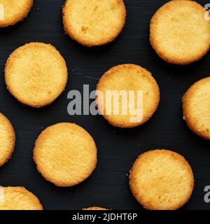 Hausgemachte Butterkurzbrote auf schwarzem Hintergrund, Draufsicht. Flach liegend, über Kopf, von oben. Stockfoto