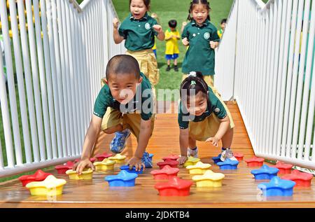 YANTAI, CHINA - 23. JUNI 2022 - Kinder spielen Kletterspiele im Fumiao Kindergarten im Bezirk Fushan in Yantai, der Provinz Shandong in Ostchina, Stockfoto