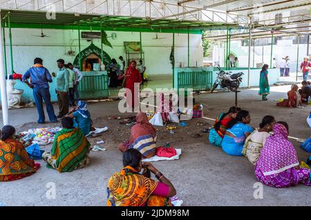 Bijapur, Karnataka, Indien : Pilger sitzen vor den Gräbern eines Adil shahi Generals und seines spirituellen Beraters Abdul Razzaq Qadiri im 17.. Jahrhundert Stockfoto