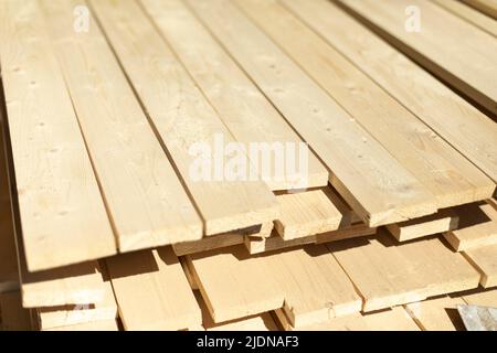 Platten auf Lager. Weiße Bretter liegen im Stapel. Baumaterial in der Schreinerei. Stockfoto