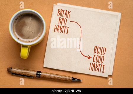 Brechen Sie schlechte Gewohnheiten, bauen Sie gute Gewohnheiten - motivierende Erinnerung auf einer Serviette mit einer Tasse Kaffee, Selbstentwicklung Konzept Stockfoto