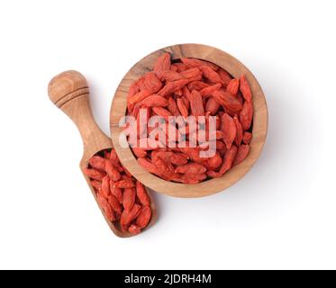 Draufsicht auf Goji-Beeren in Holzschüssel und Schaufel isoliert auf weiß Stockfoto