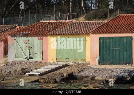 Alte bunte oder bunte Bootsschuppen am Strand oder Plage de Bregançon Bormes-les-Mimosas Var Provence Frankreich Stockfoto