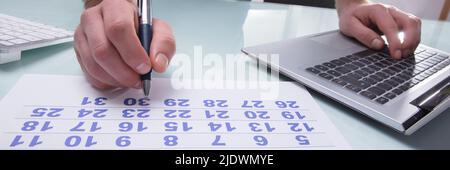 Nahaufnahme der Kaufmann Hand Kennzeichnung mit Stift im Kalender am Arbeitsplatz Stockfoto